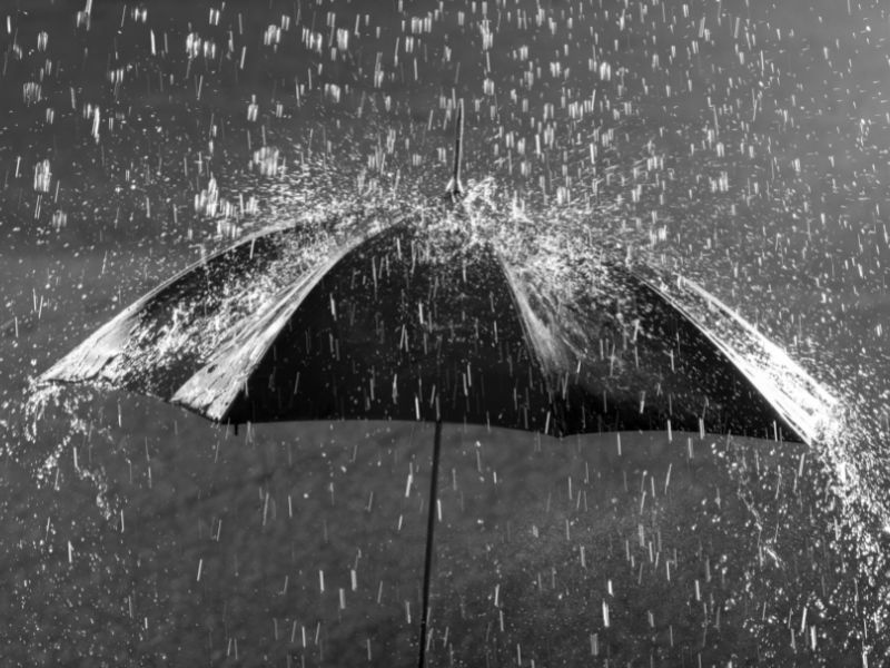 rain precipitation falling on umbrella